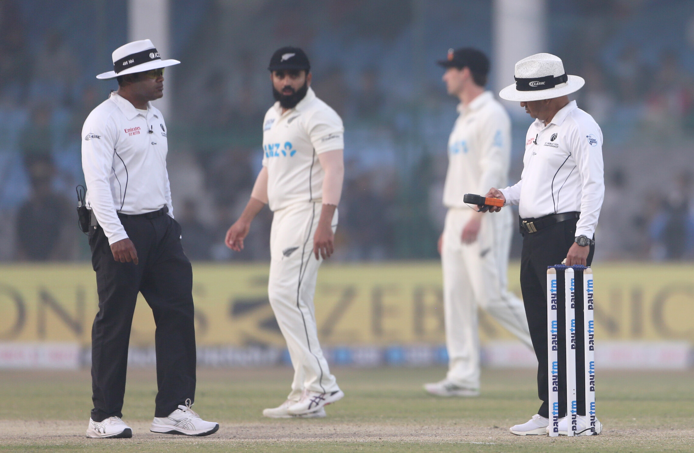 An umpire checks the light on Day-3 of the 1st Test match between India and New Zealand