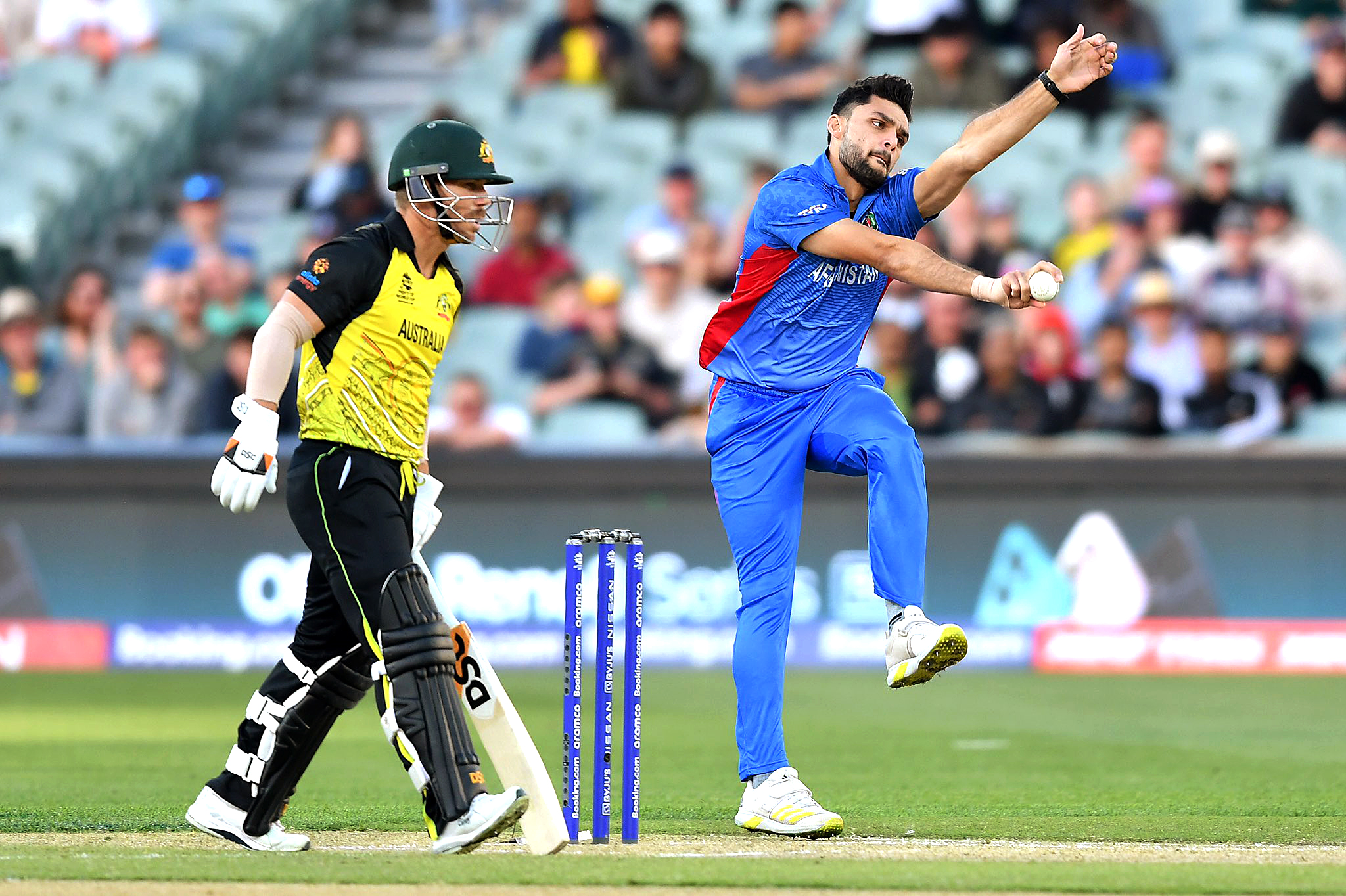 Afghanistan's Naveen-ul-Haq bowls during a match against Australia