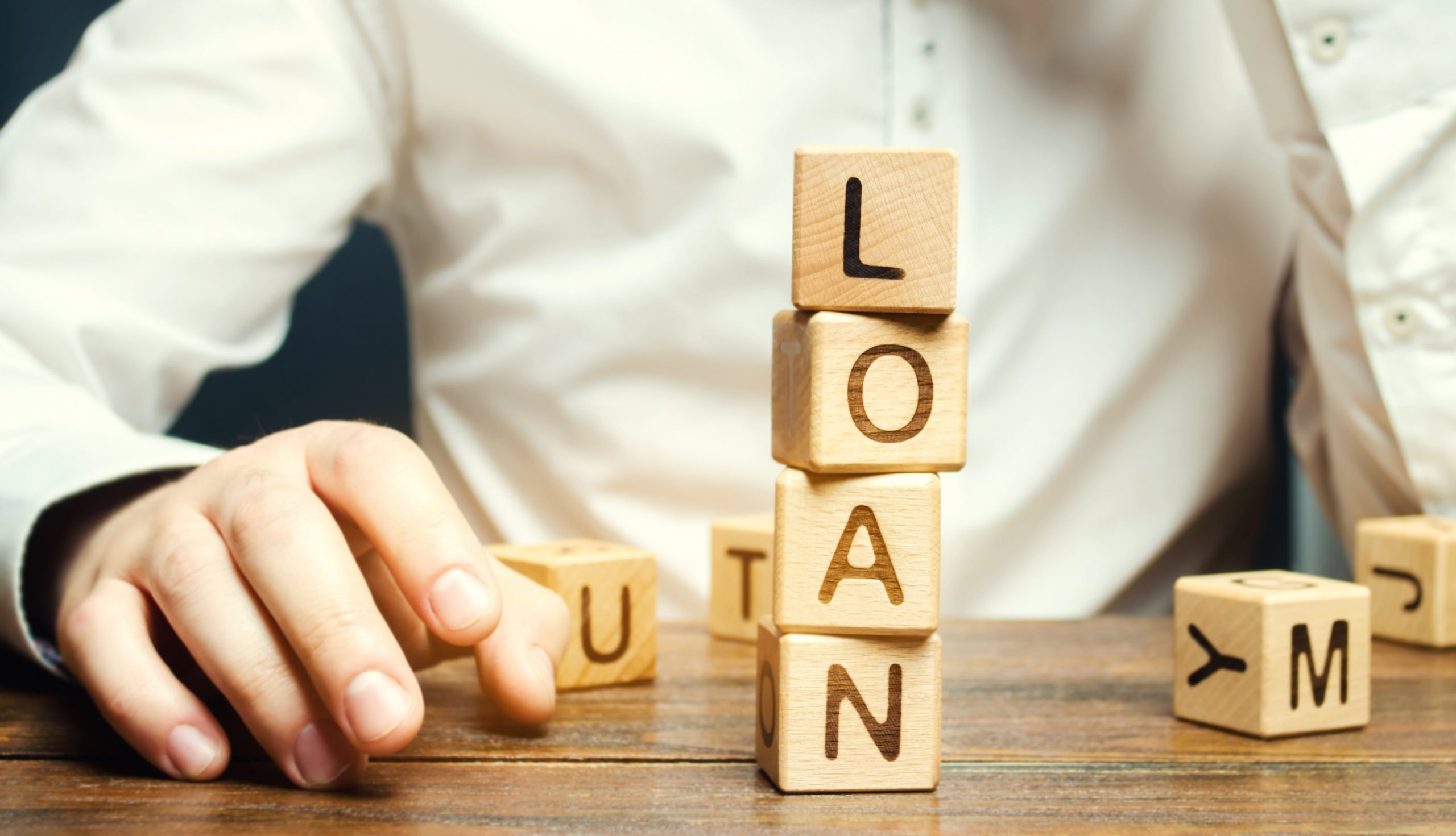 wooden-blocks-with-the-word-loan-and-businessman-2022-11-09-06-32-04-utc-min