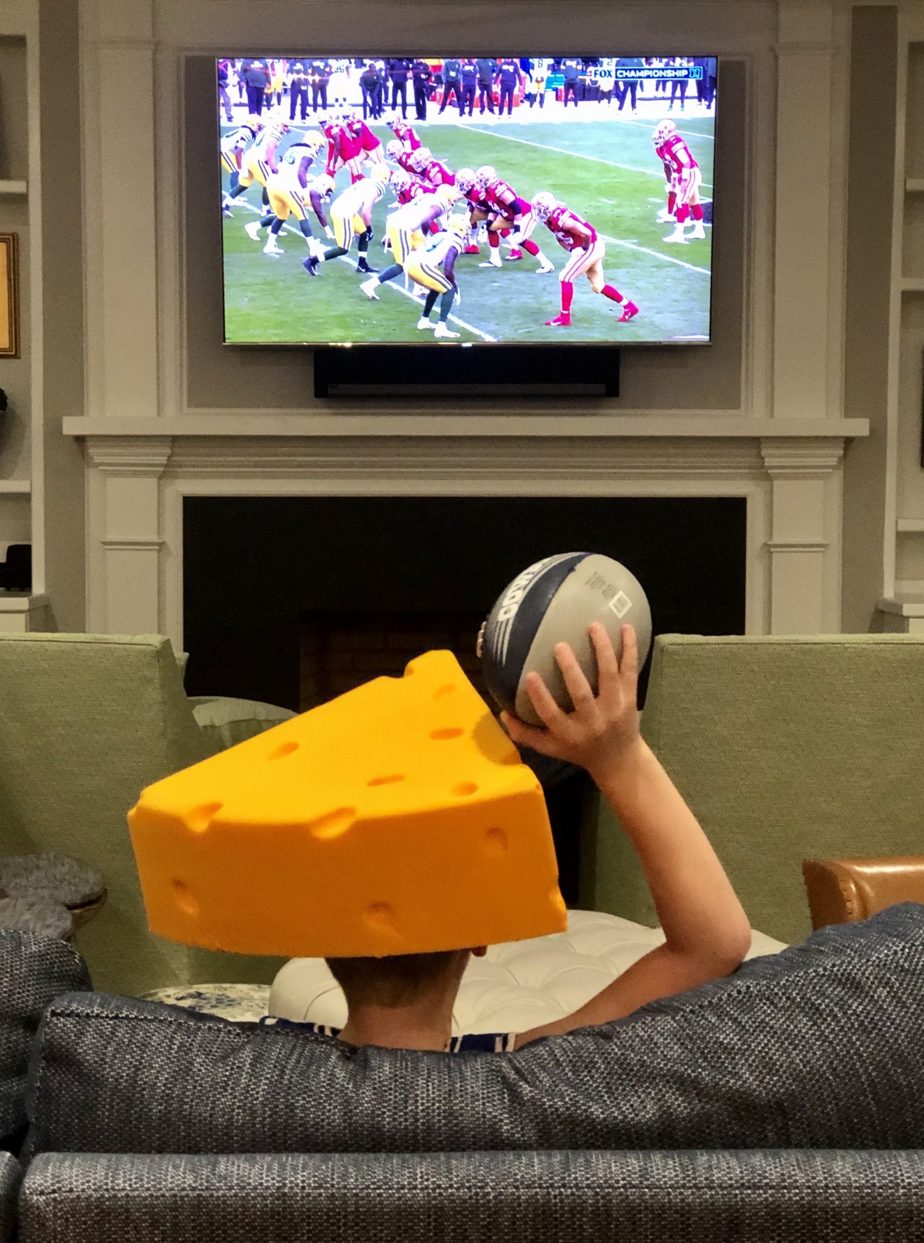 child-football-fan-watching-football-at-home-holdi-2022-11-15-12-41-51-utc-min